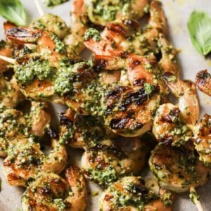 grilled pesto shrimp on wooden skewers close up photo.