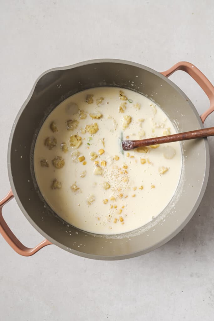 mixing the broth for corn chowder.