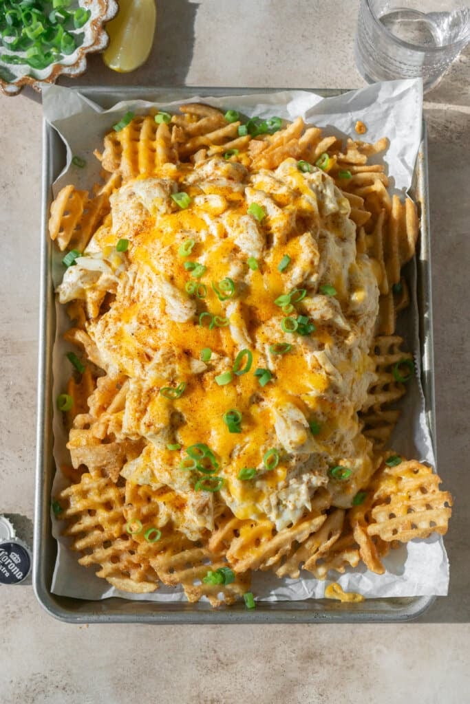 Fully baked crab fries with a green onion garnish.