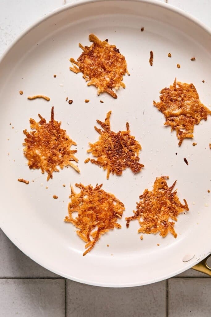 Making Parmesan crisps in a skillet.