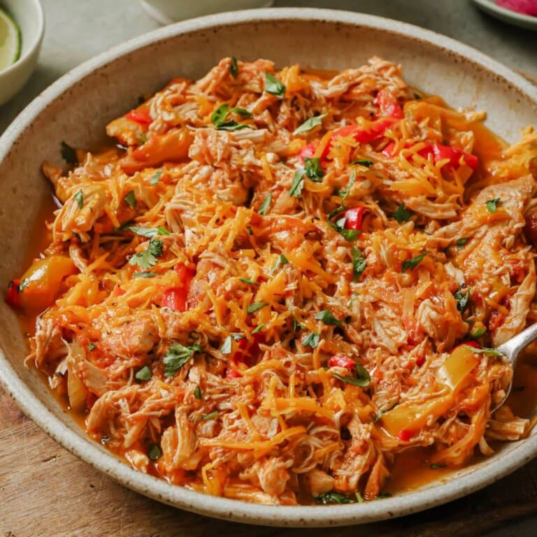 slow cooker chicken enchiladas in a large serving bowl.