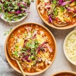 Bowls of stuffed pepper soup garnished with parsley and cheese.