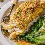 Air fried halibut on a plate with a fork.