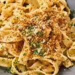 French onion pasta on a plate with toasted panko on top.