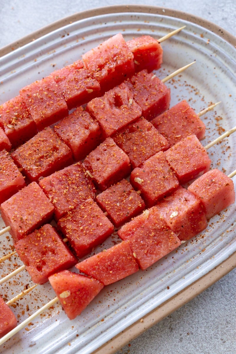 Watermelon skewers after being sprinkled with Tajin.