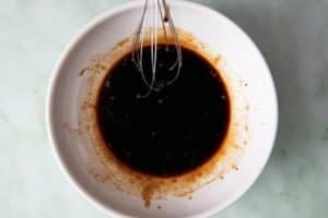 Whisking dipping sauce in a medium bowl.