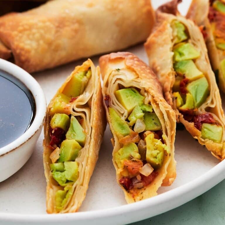 Halved egg rolls on a plate.