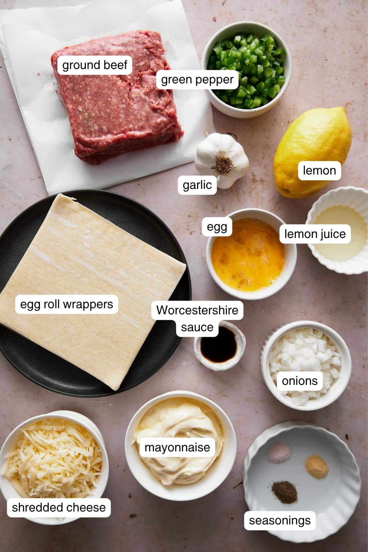 Labeled ingredients for philly cheesesteak egg rolls.