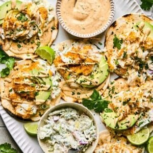 Top down view of a platter full of air fryer fish tacos.