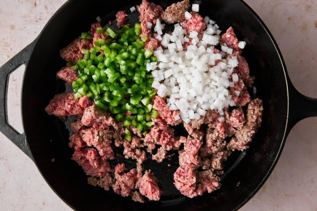 Cooking egg roll filling in a skillet.