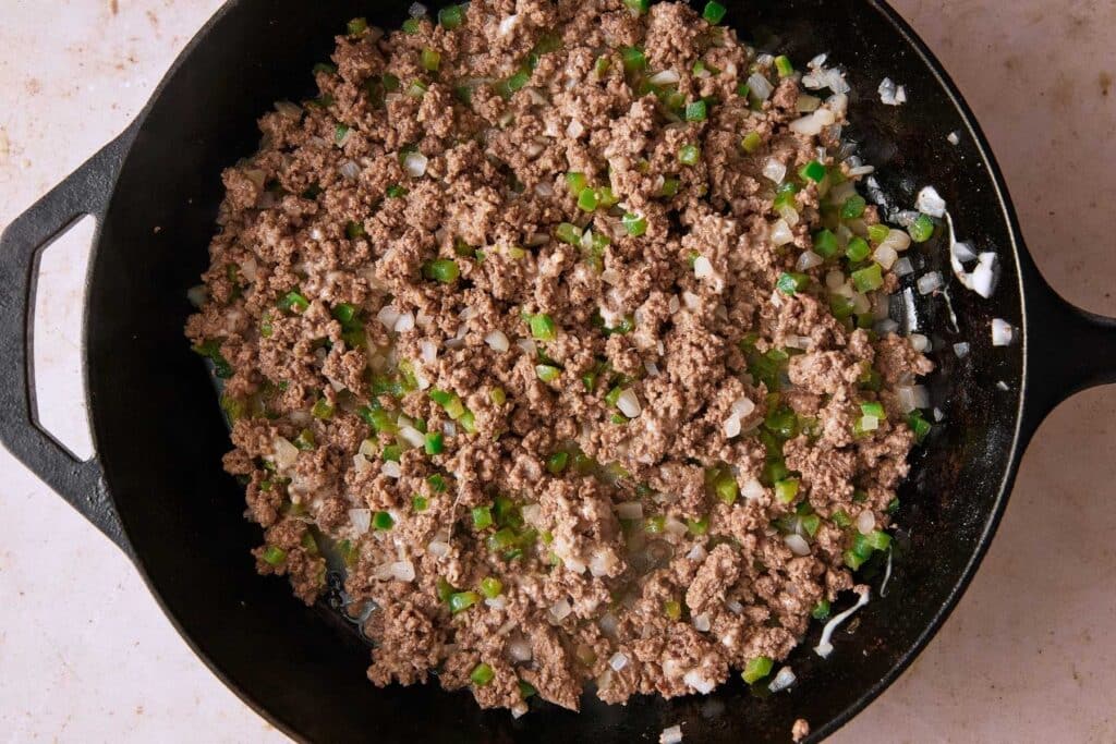 Cooked egg roll filling in a cast iron skillet.