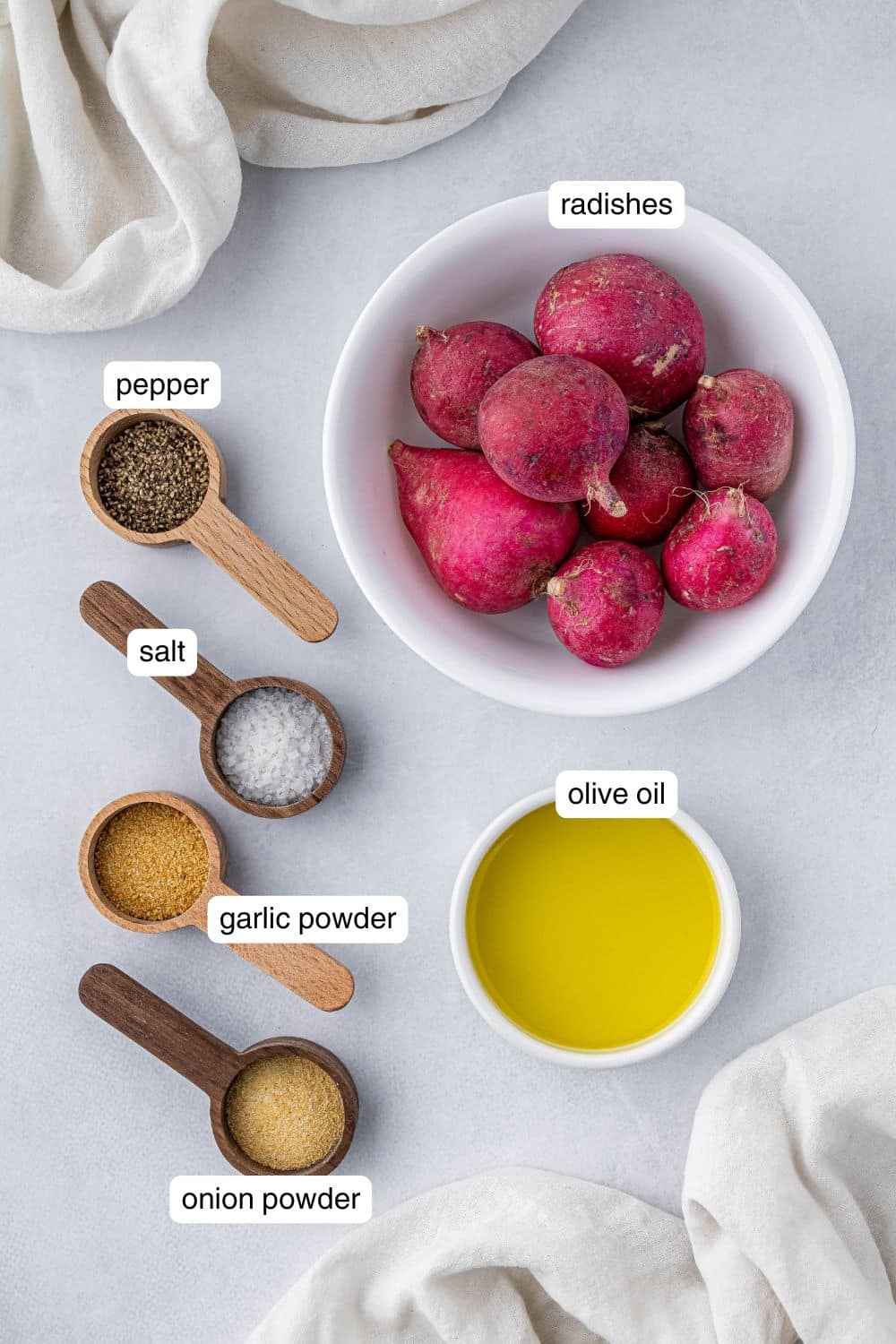 Radishes, olive oil, salt, pepper, garlic powder, and onion powder in small ingredient bowls.