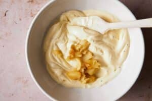 Mixing roasted garlic into mayo aioli.