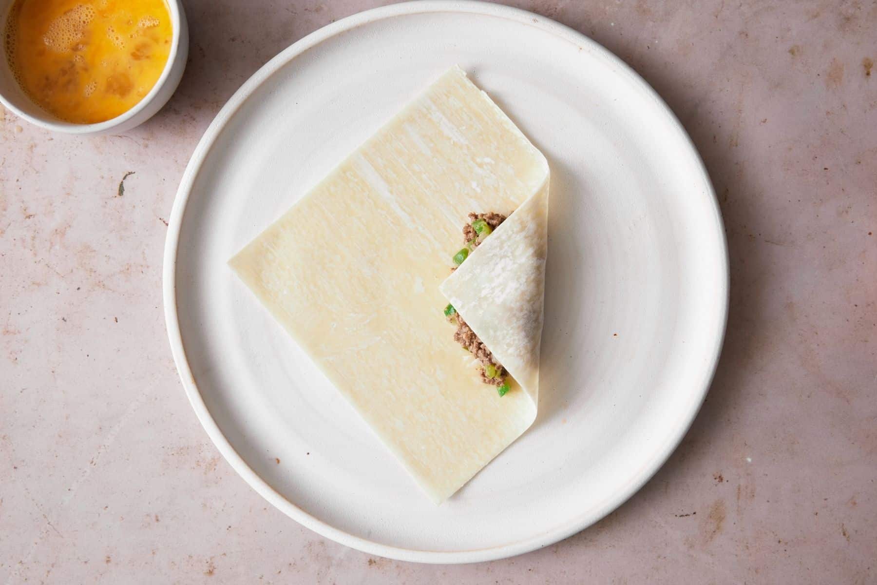 Wrapping up a cheesesteak egg roll.