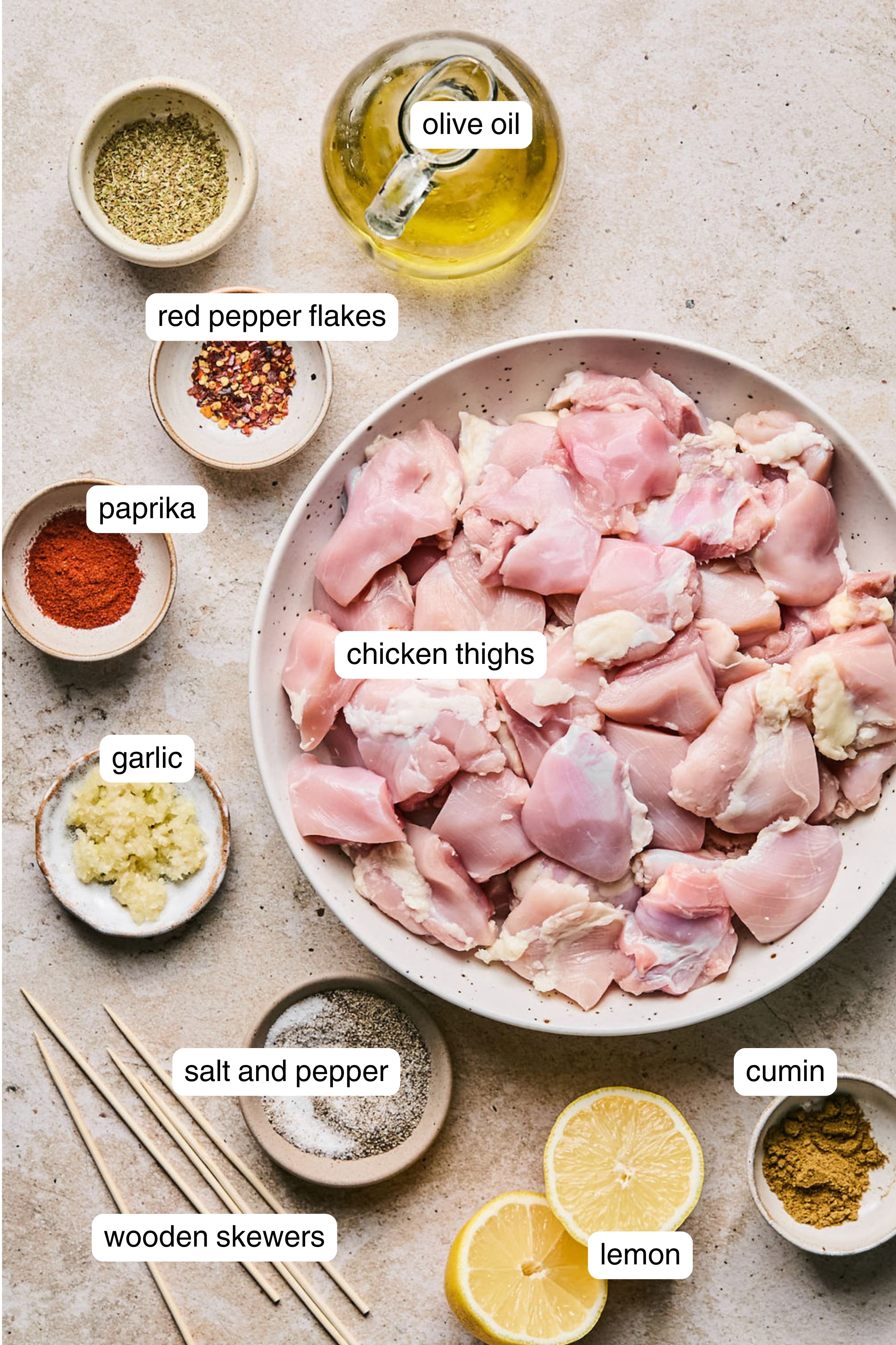 Labeled ingredients for air fryer greek chicken skewers.