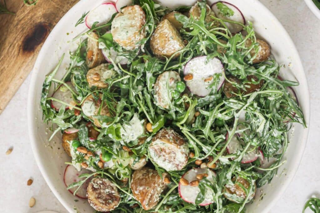 Assembled roasted potato salad in a bowl.