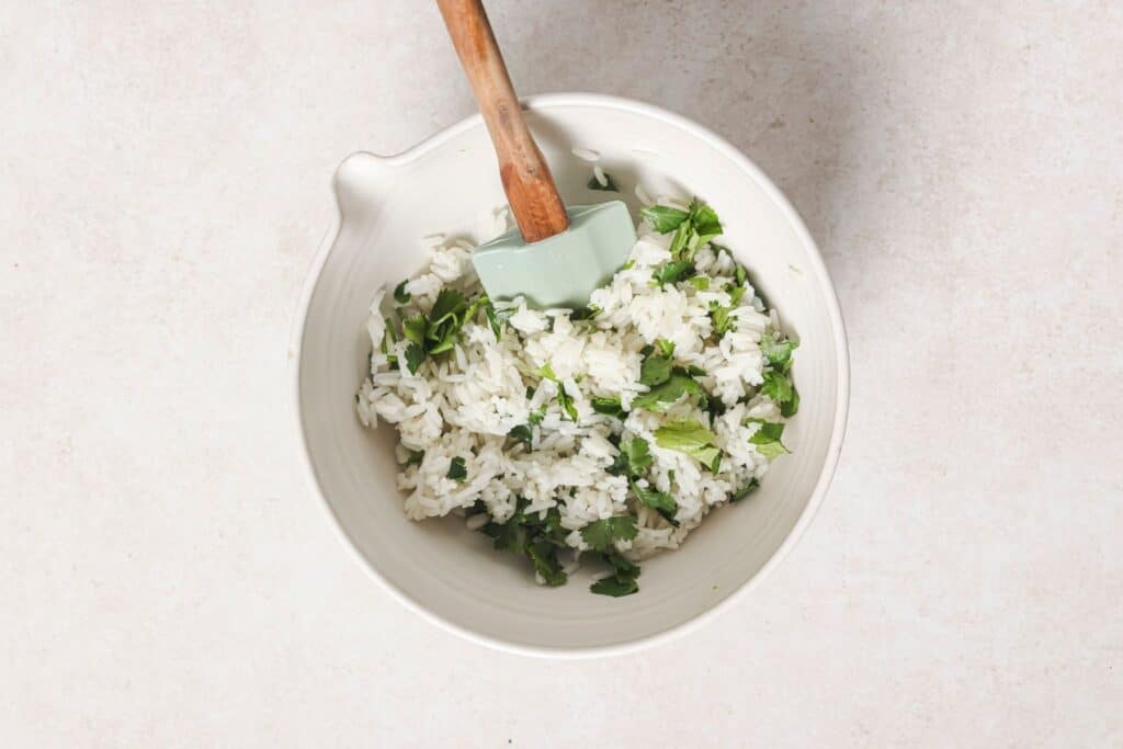 Mixing rice with cilantro.