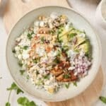A bowl of street corn chicken and rice.