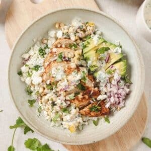 A bowl of street corn chicken and rice.