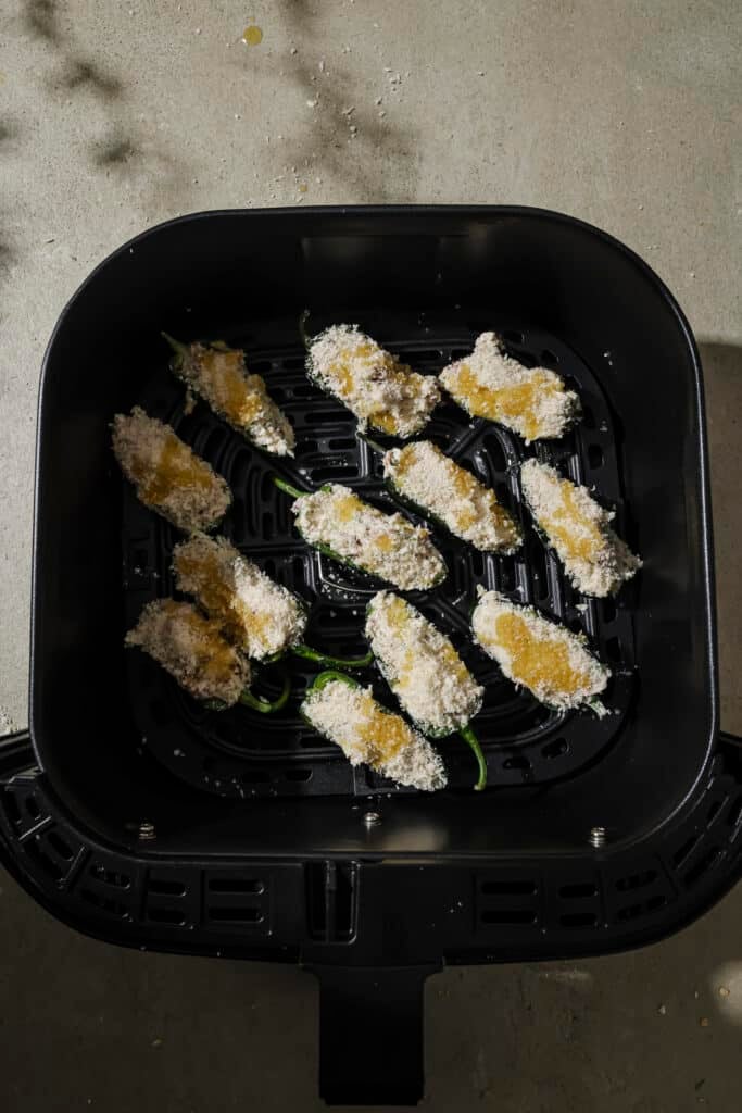 Jalapeno poppers in the air fryer basket.