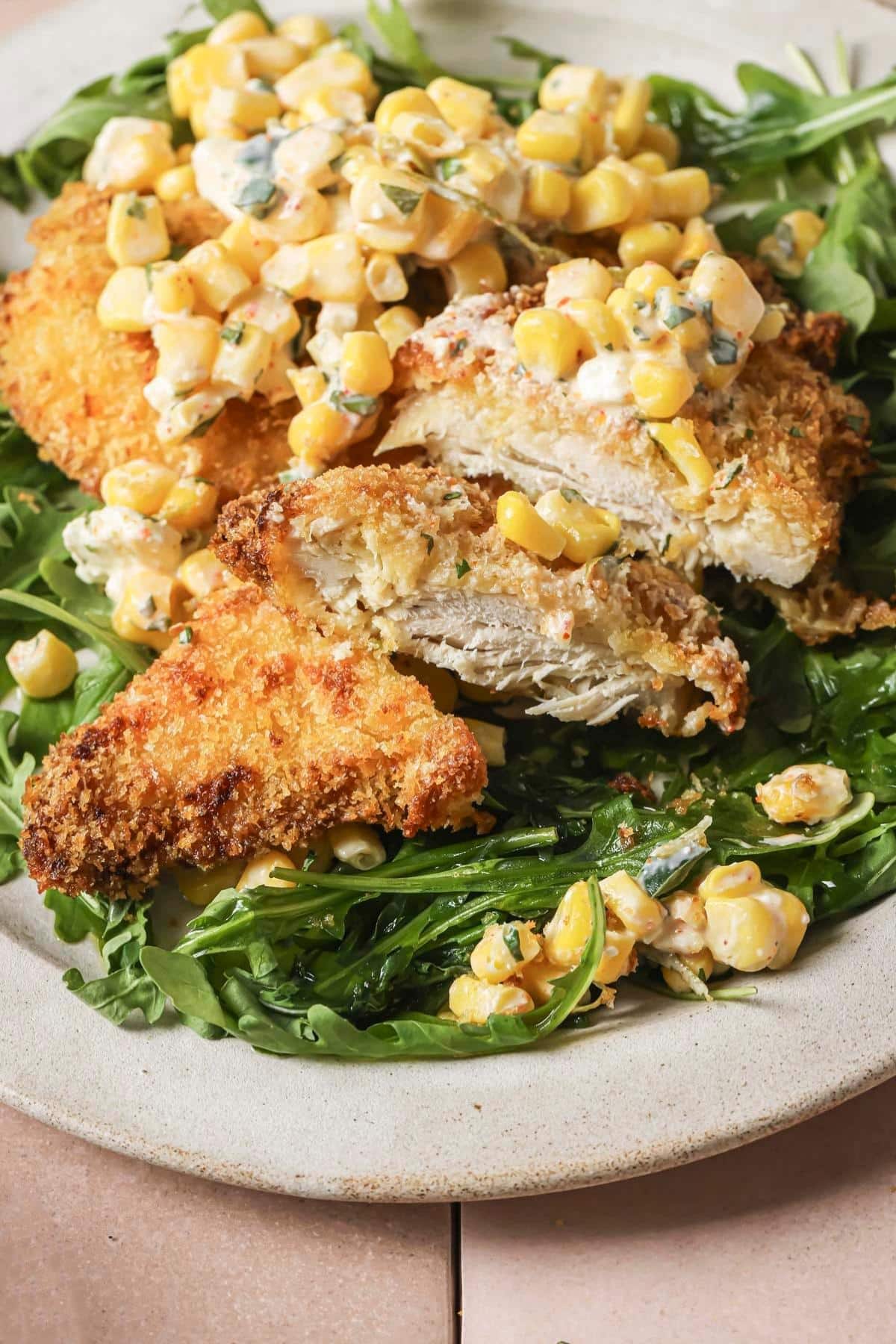 Air fryer chicken served with mexican street corn.