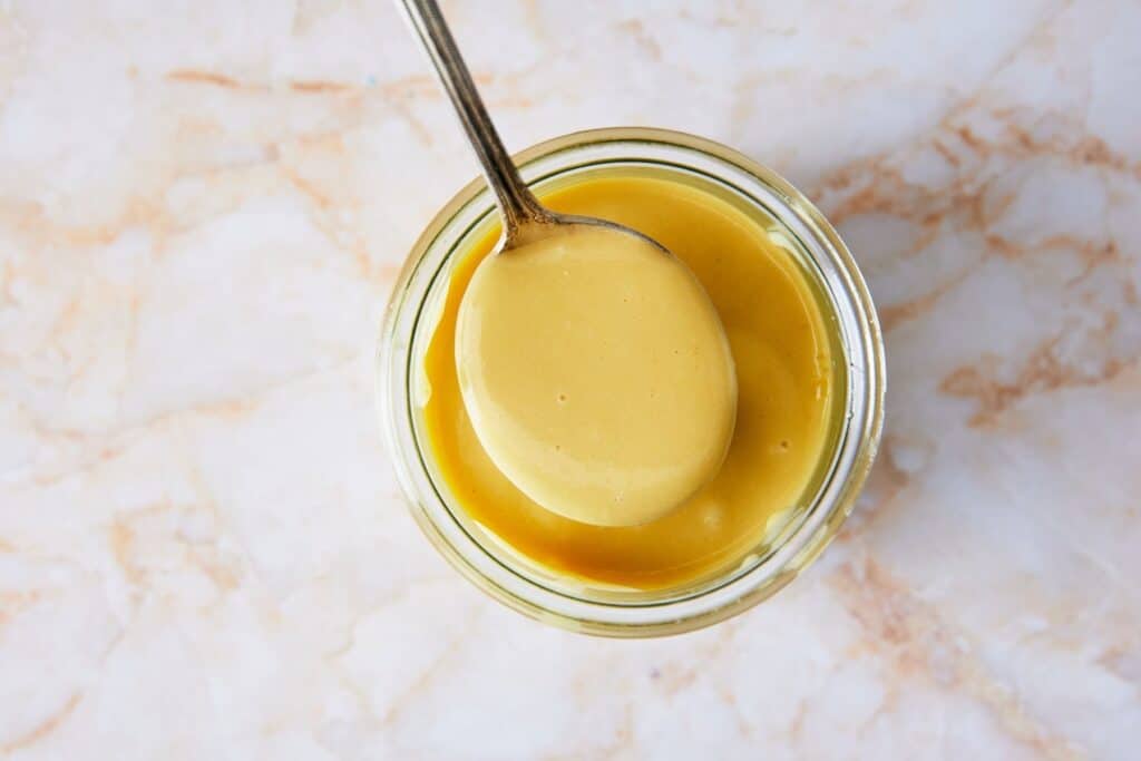 Mixing dressing in a small bowl.