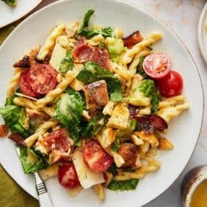 A plate of chicken caesar pasta salad.