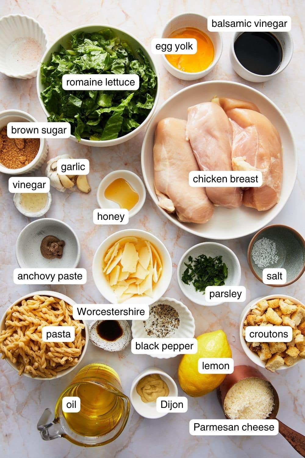 Labeled ingredients for chicken caesar pasta salad.