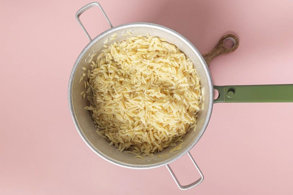 Cooked orzo in a pot.