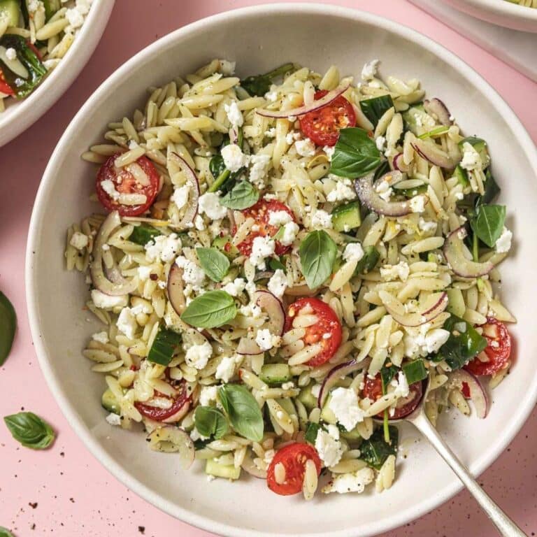 A bowl of spinach orzo pasta salad.