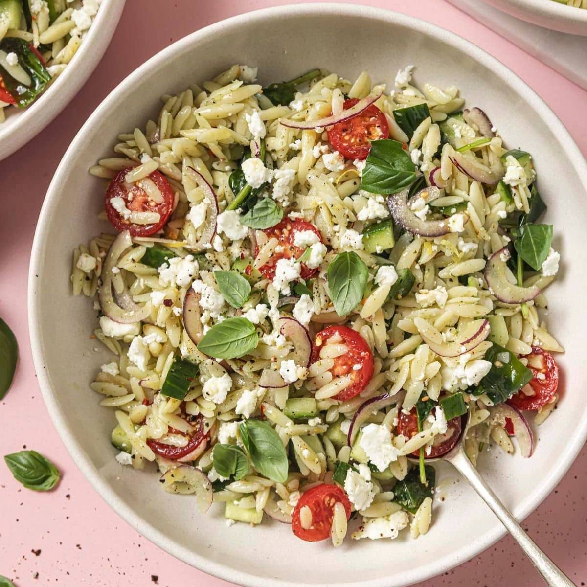 A bowl of spinach orzo pasta salad.