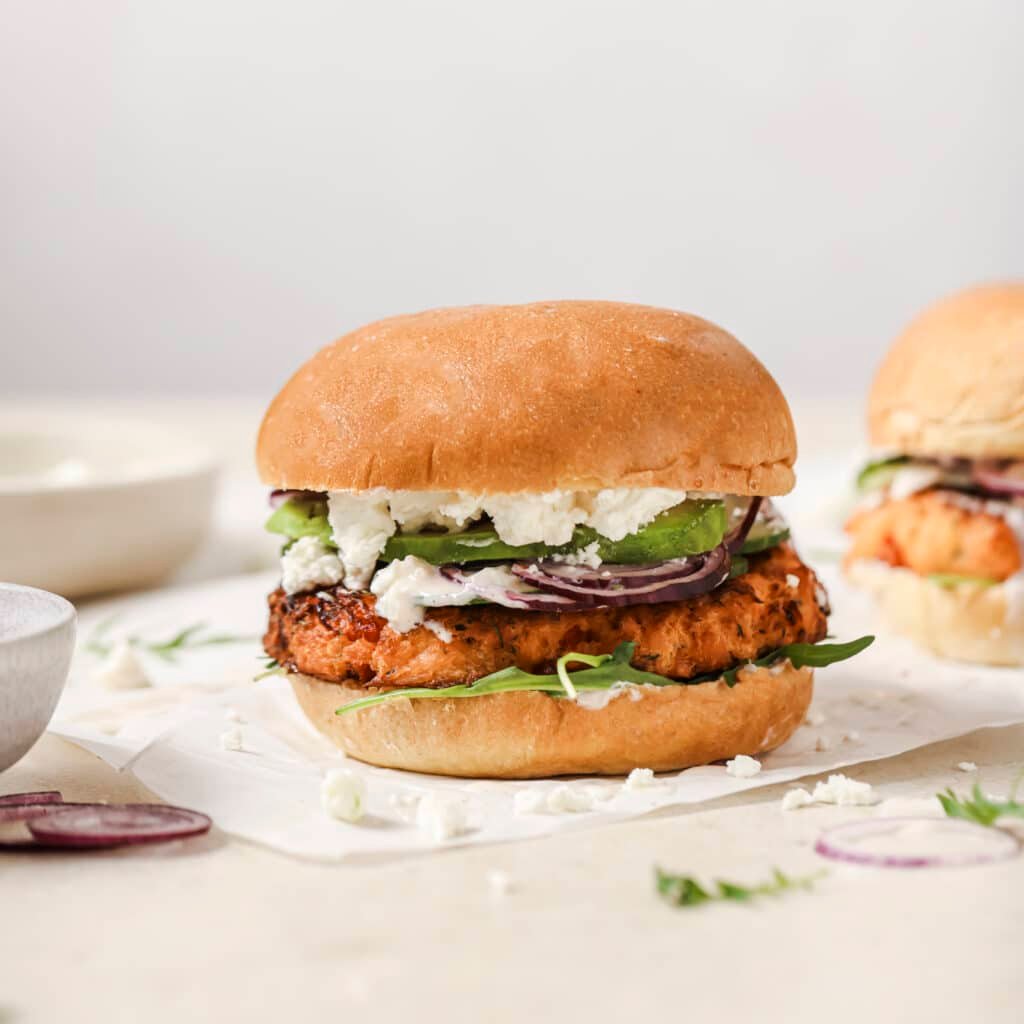 Salmon burger sitting on table