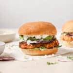 Salmon burger sitting on table