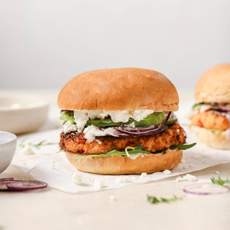 Salmon burger sitting on table
