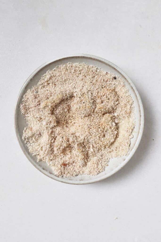 Coating shrimp in crispy breading.