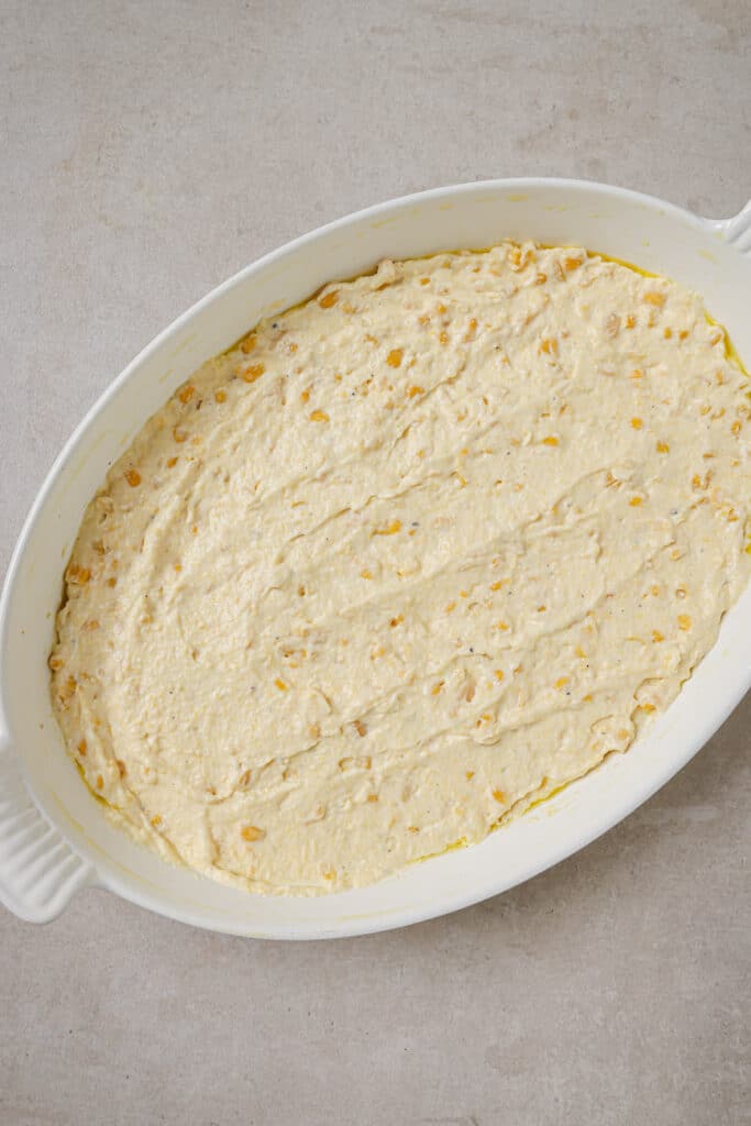 Corn casserole smoothed out into casserole dish.