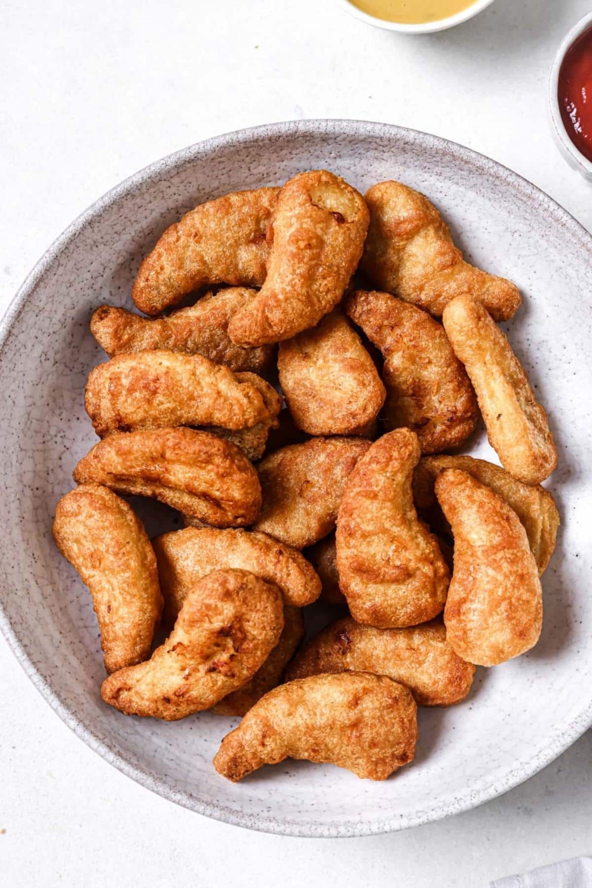 A plate of air fryer frozen chicken tenders.