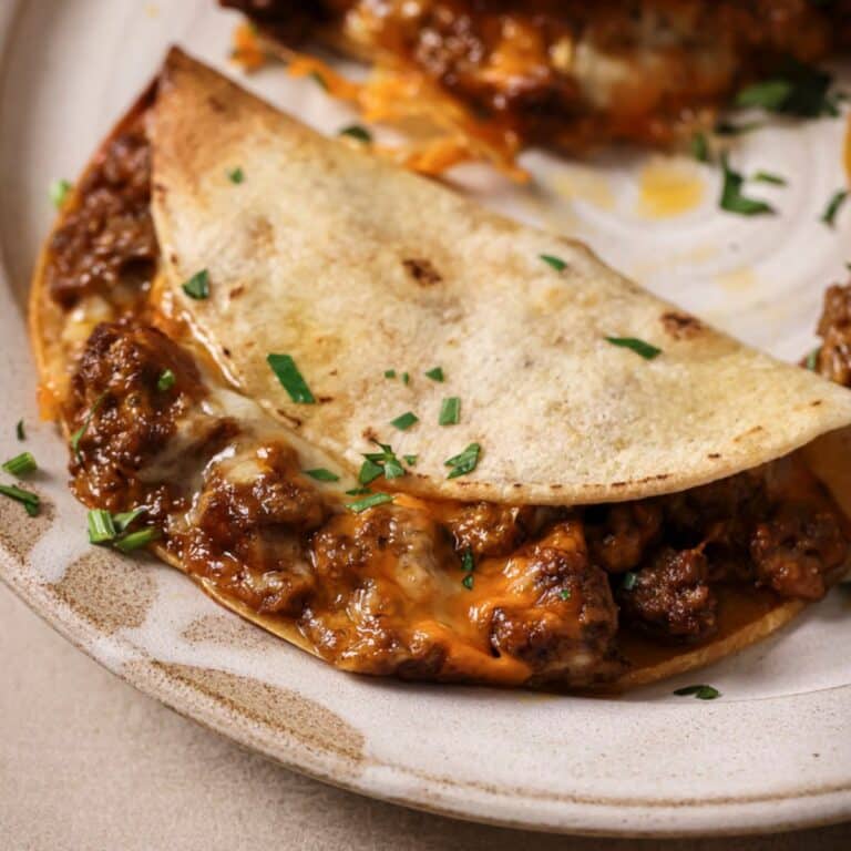 An air fryer taco on a white plate.