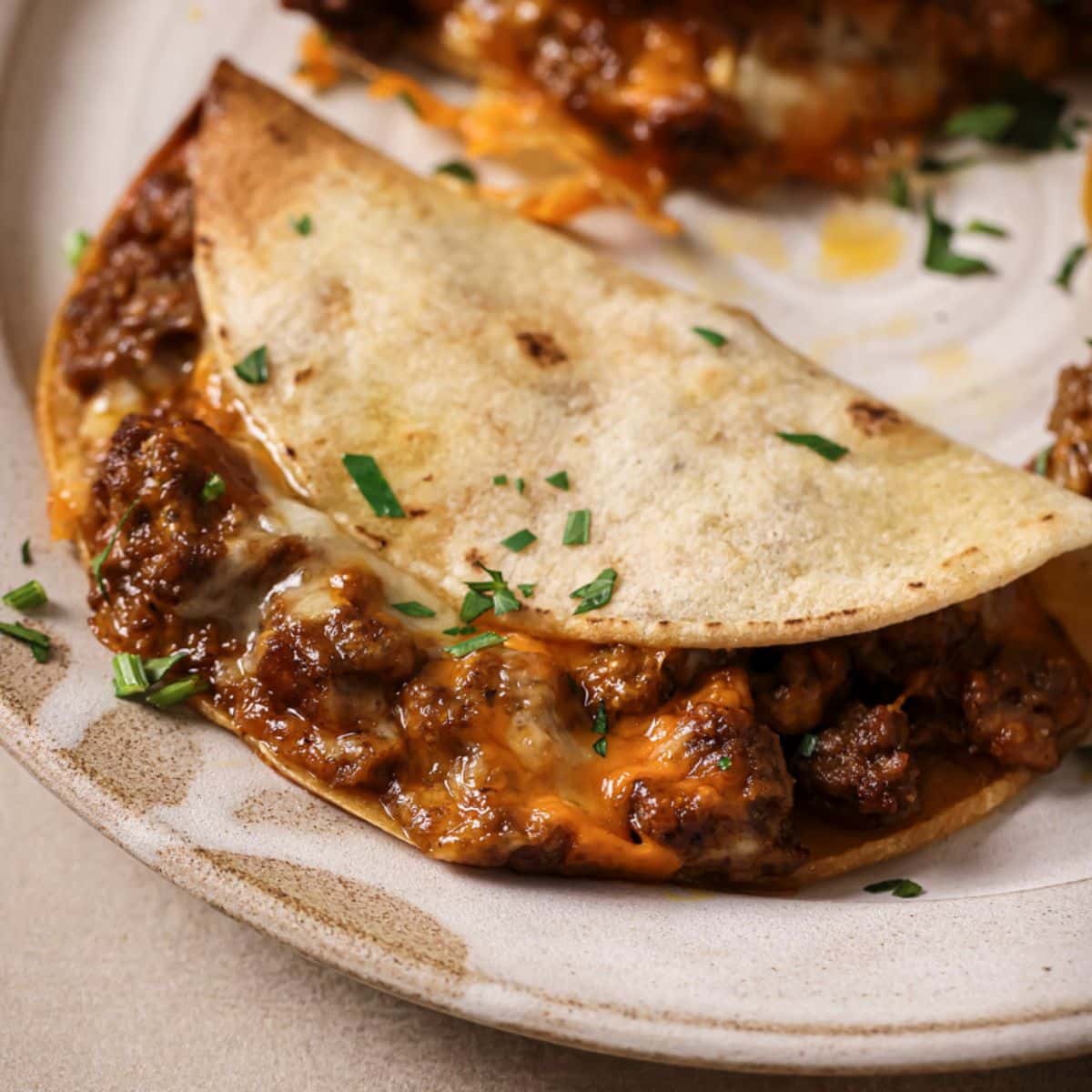 An air fryer taco on a white plate.