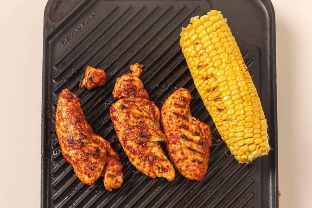 Grilling chicken and corn.