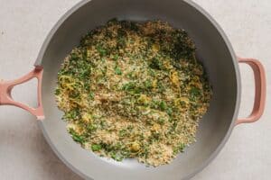 Toasted panko with parsley and lemon zest in a pan.