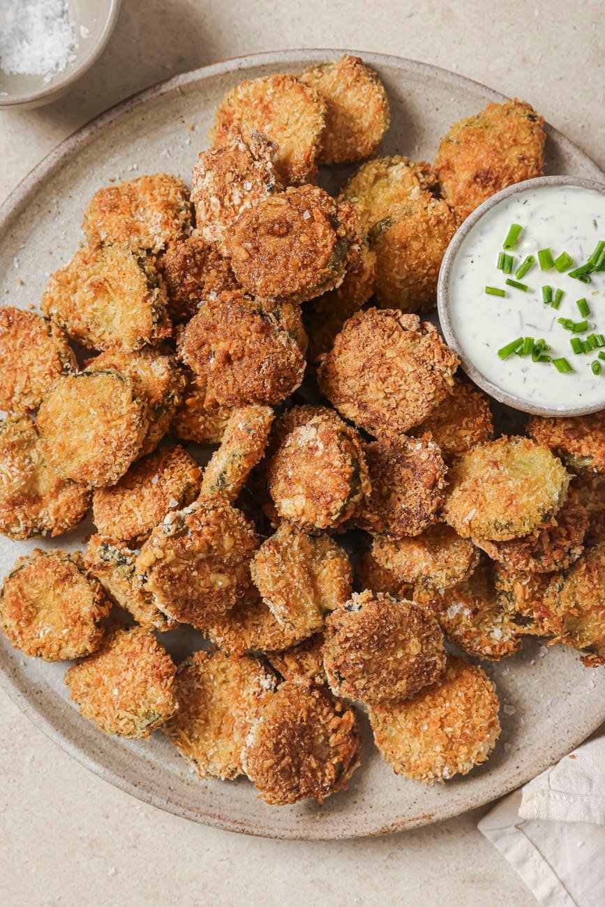 Crispy air fryer fried pickles served with ranch dressing for dipping.