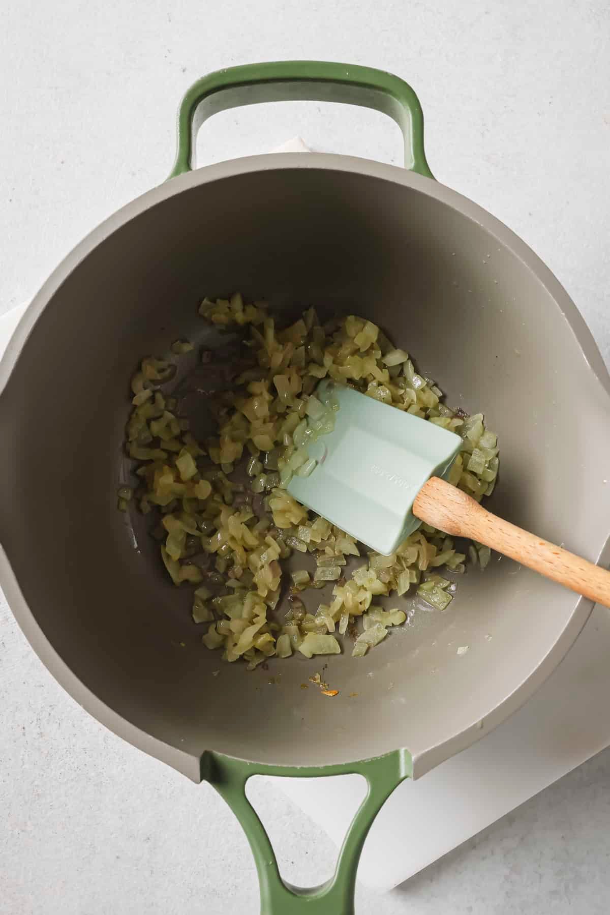 Sautéing onions and shallot in a pan.