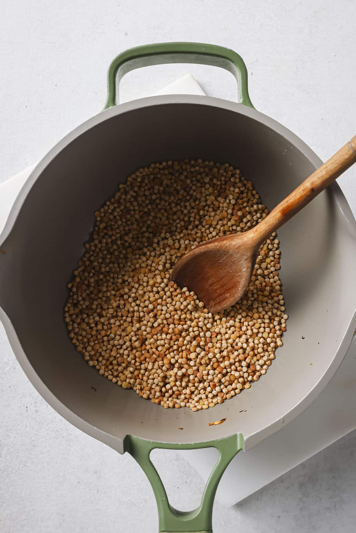 Toasting couscous in a pan.