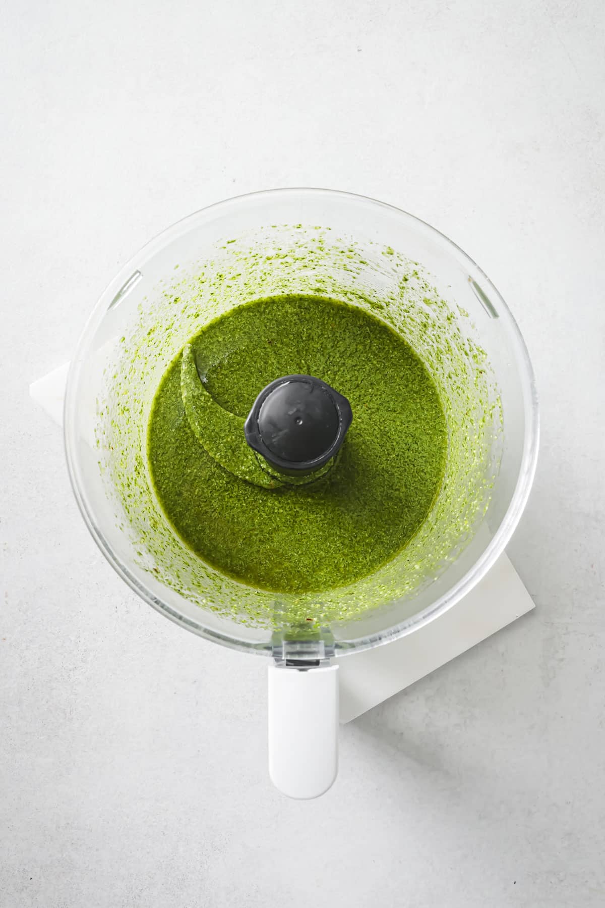 Pesto dressing blended in a food processor.
