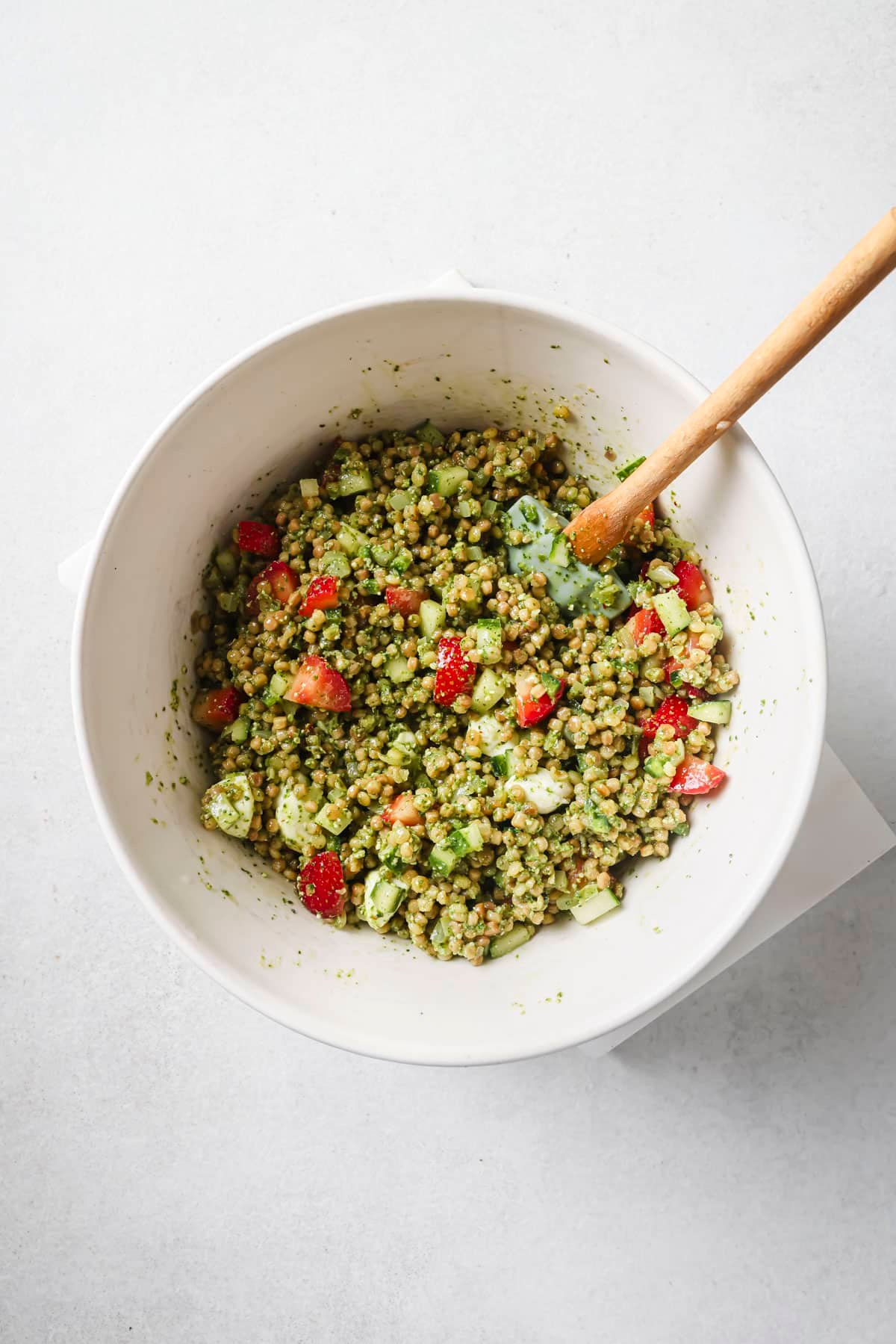 Israeli couscous salad combined with pesto dressing and strawberries.