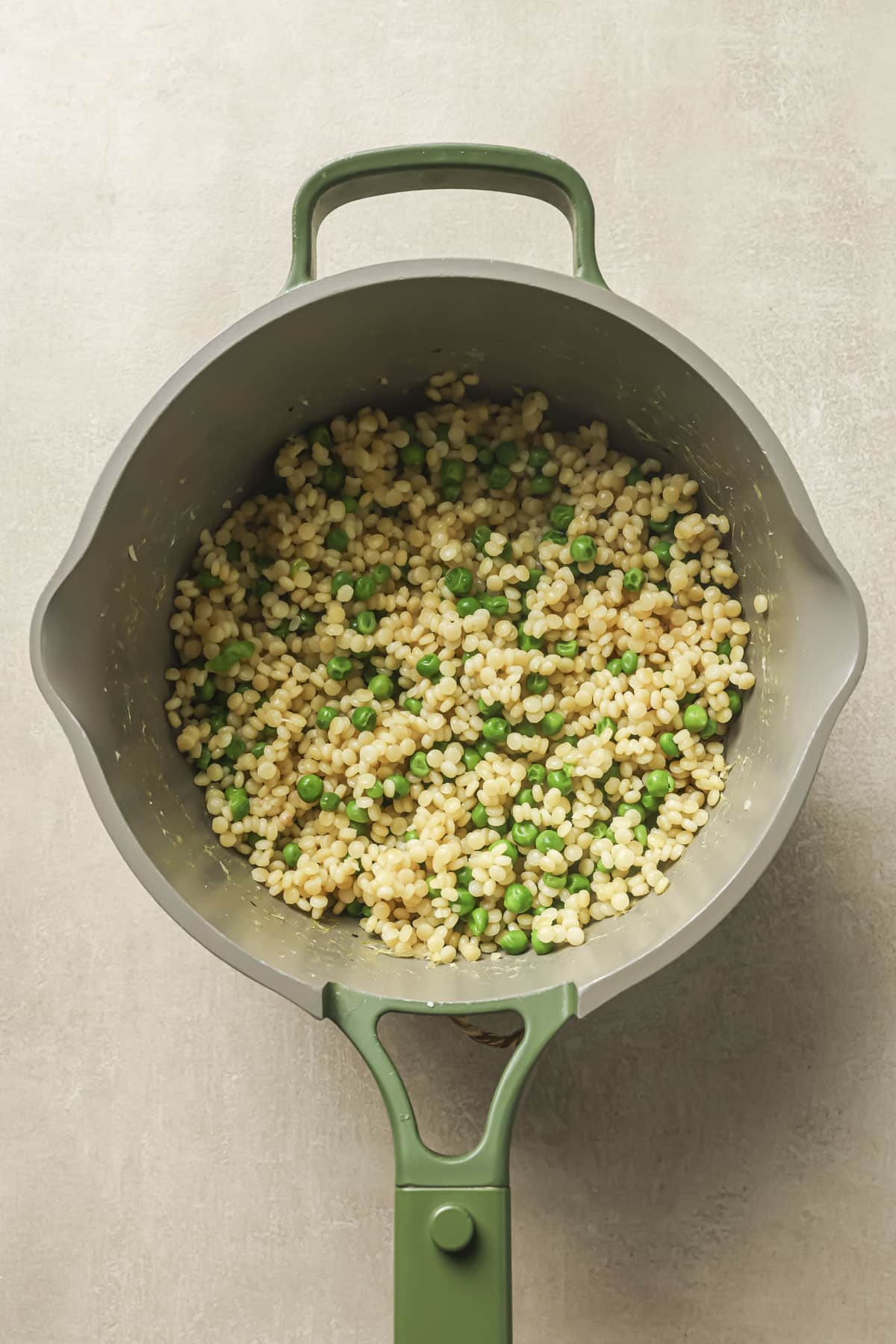 Peas added to couscous in a medium saucepan.