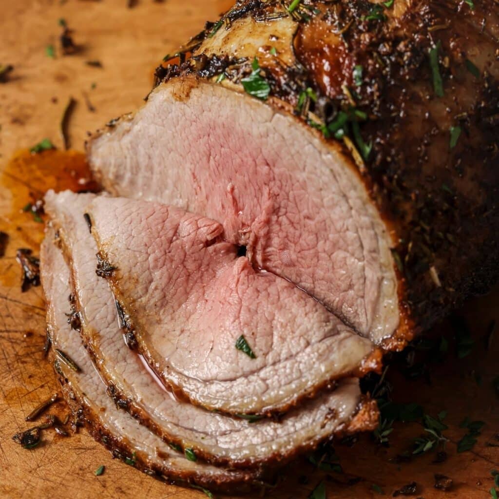 Sliced beef brisket on a cutting board.