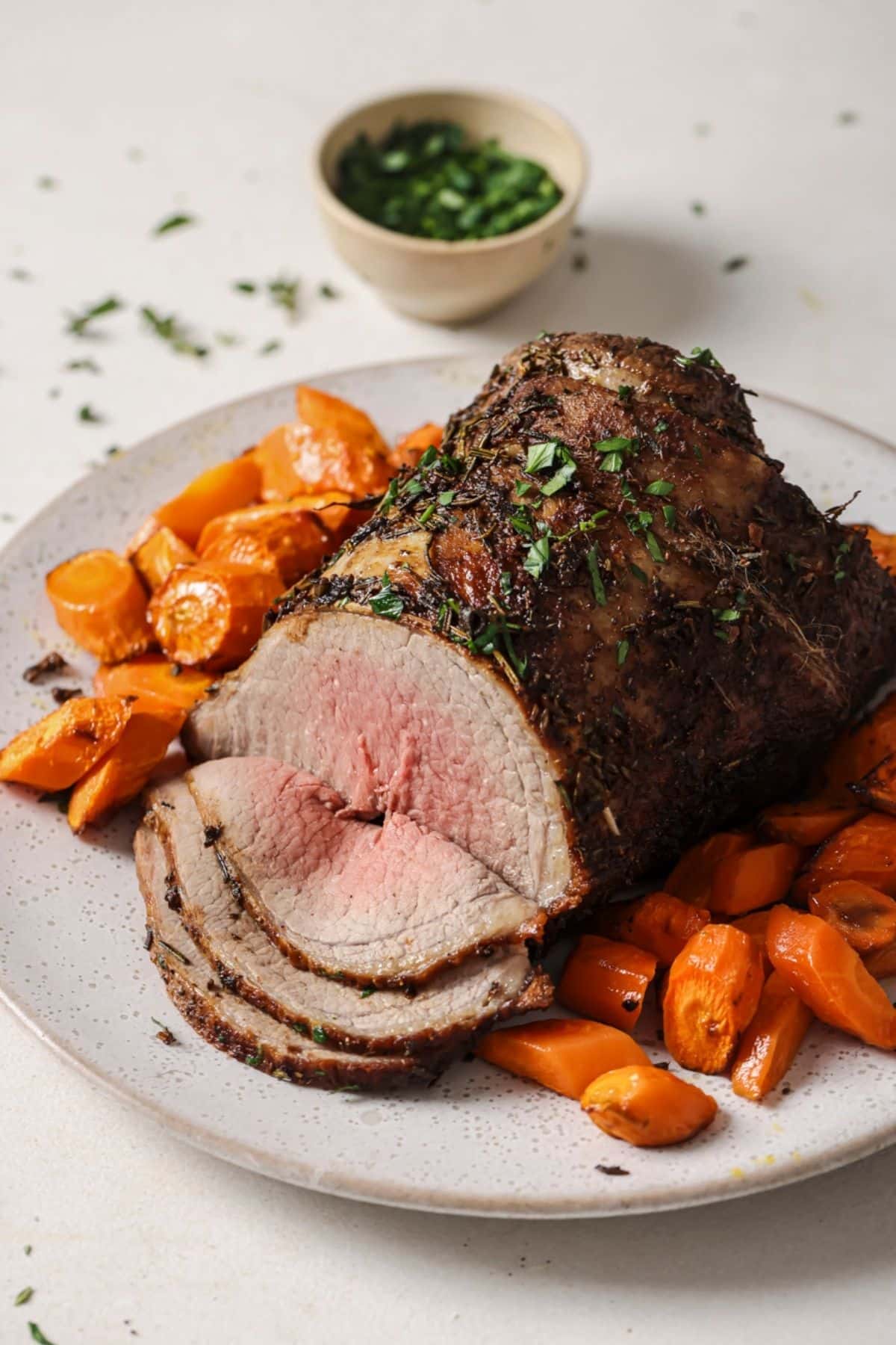 Air fryer brisket on a plate with roasted carrots.