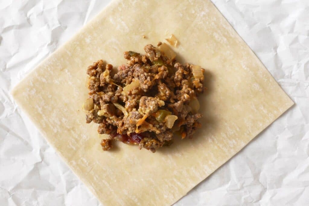 Cheeseburger filling on an egg roll wrapper.